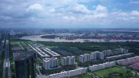 Drone-fly-in-over-Sala-in-Ho-Chi-Minh-City,-Vietnam-towards-river-port-and-new-residential-development