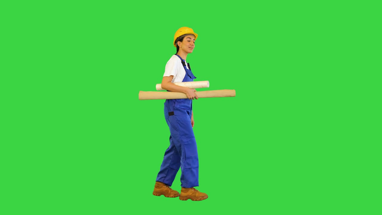 Woman holding wallpaper rolls walking on a Green Screen, Chroma Key