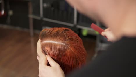 Professional-unrecognizable-hair-stylist-prepares-woman's-hairs-for-coloring-in-beauty-studio,-woman-changes-her-look