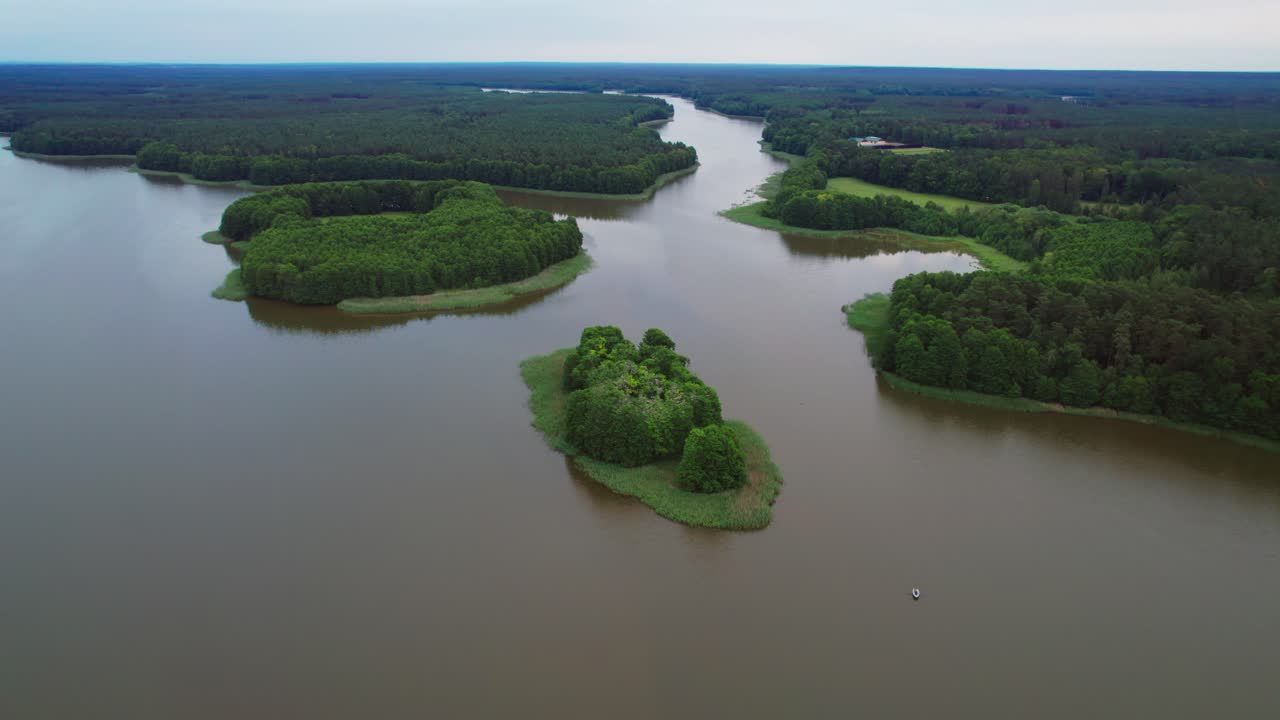 Forest lake with a tiny island in Masurian Lake District