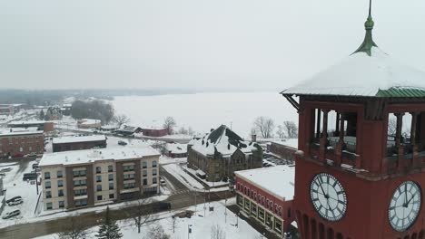 Aerial,-University-of-Wisconsin-Stout-campus-during-winter,-focus-on-clock-tower