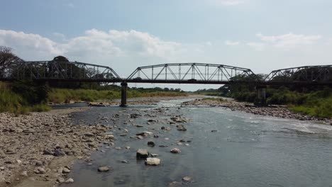 view of bridge over river with rocks