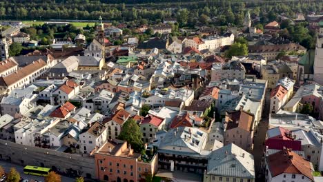 aerial view of mountain town of austria with churches,colorful houses, tower, autumn scenery at sunset, river austrian alps , austria, europe