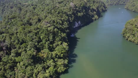 surrounded by scenic riverbanks and dense vegetation jet ski powers on