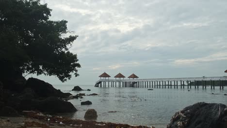 calm and quiet beach tanjung balau pier at desaru on overcast day