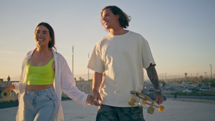 Couple Skateboarding at Sunset