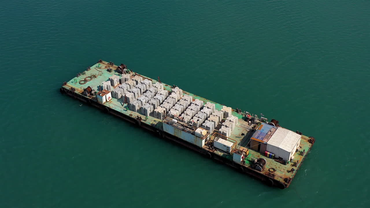 Aerial footage over barge with construction materials