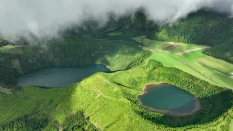 drone view near clouds of scenic rasa - and santiago lagoons at sete cidades