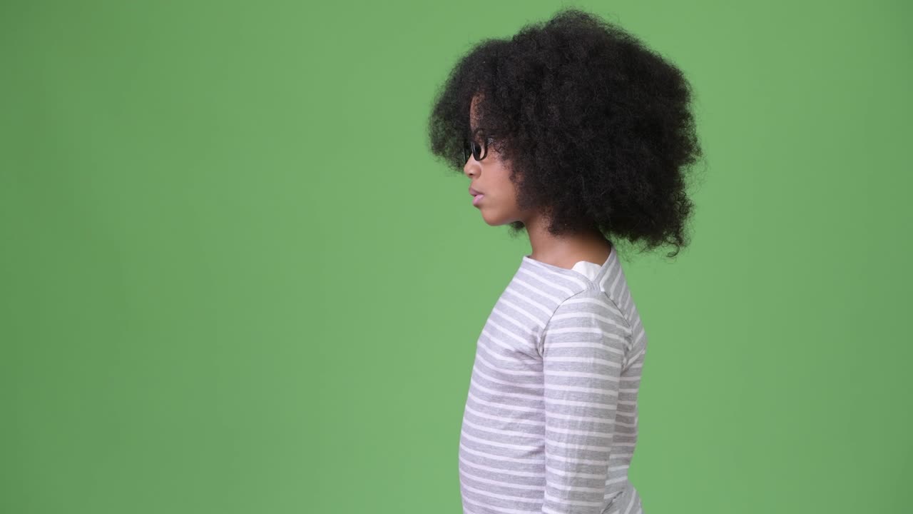 Profile view of young cute African girl with Afro hair