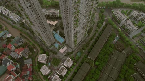 High-angle-view-of-Hanoi-skyscrapers-with-rooftop-pools-and-surrounding-greenery,-Vietnam