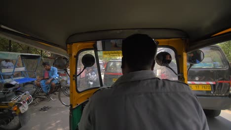 riding in tuk tuk down busy road