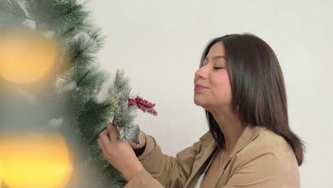 happy young attractive hispanic girl decorates advent christmas tree