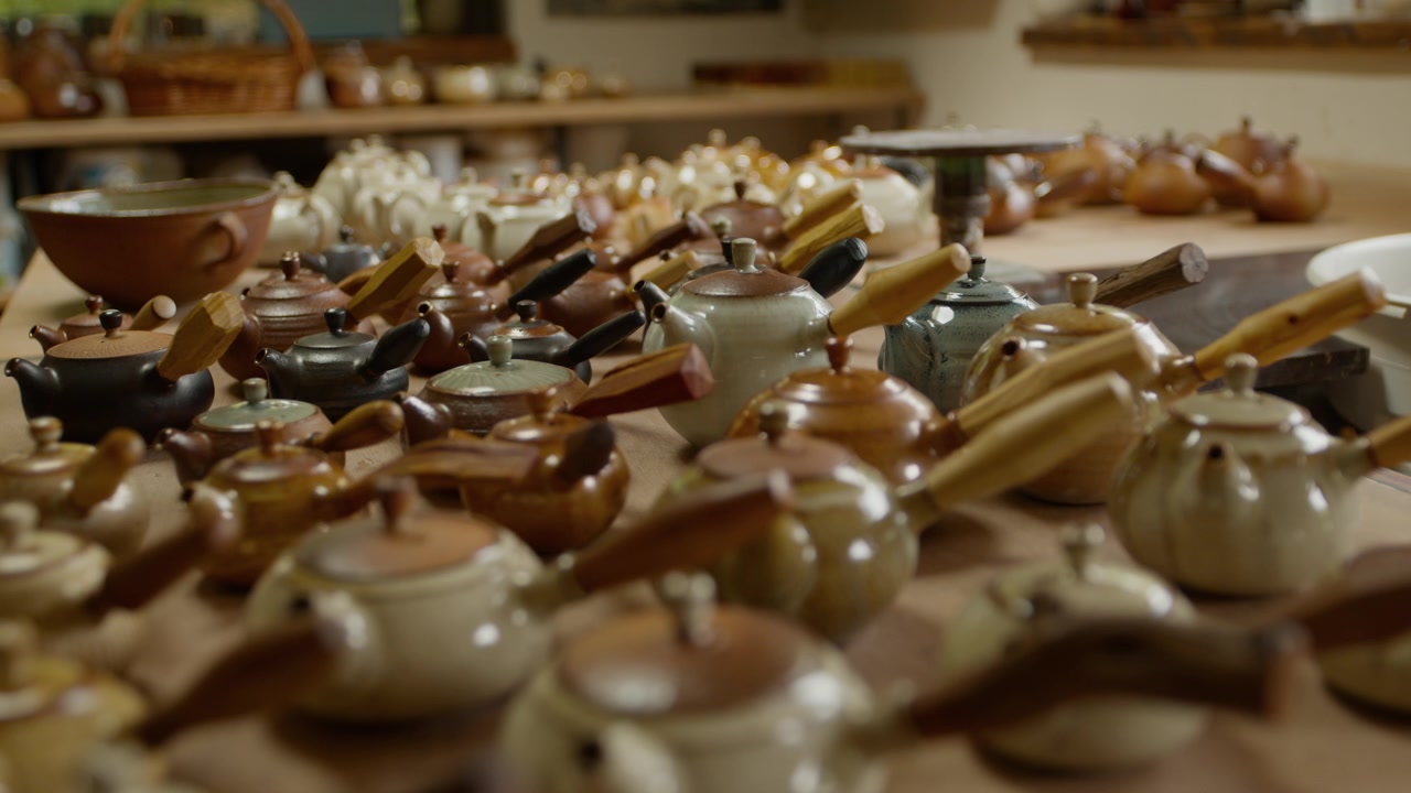 Large Collection of Handcrafted Ceramic Teapots in Pottery Studio, Showcasing Unique Designs and Glazes.