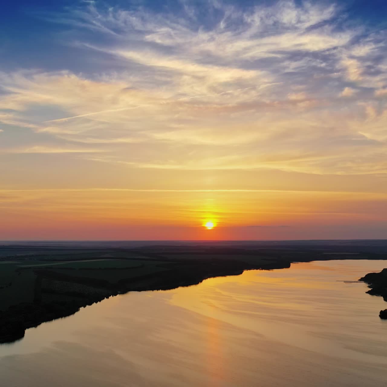 Aerial view of huge river against sunset