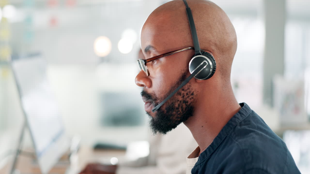 Man in a call center talking on a headset