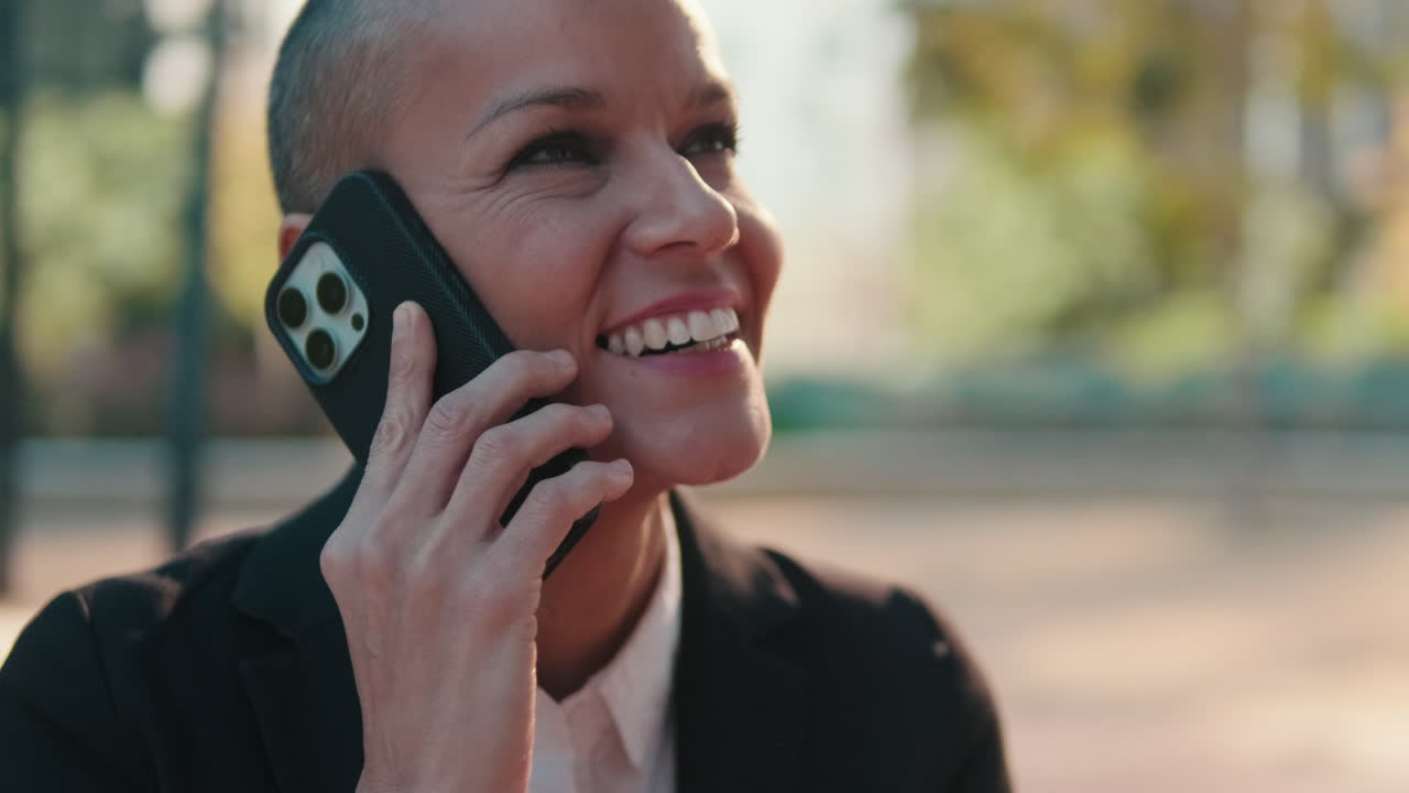 Happy Businesswoman Talking on Smartphone Outdoors