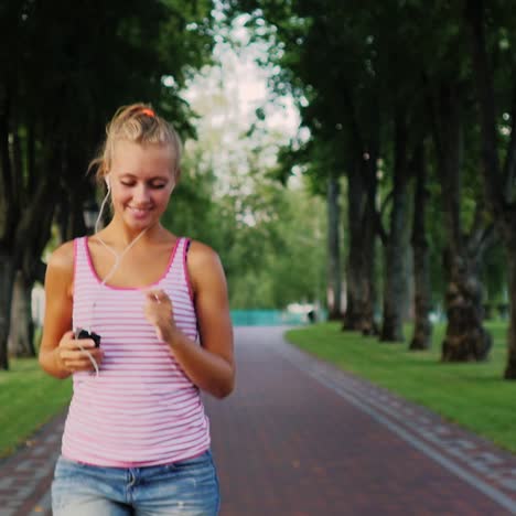 a woman is running in the park in the sun