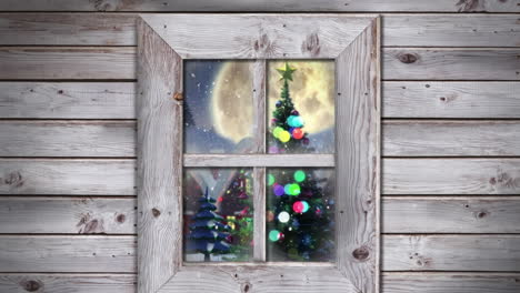 wooden window frame against snow falling over christmas tree on winter landscape against night sky