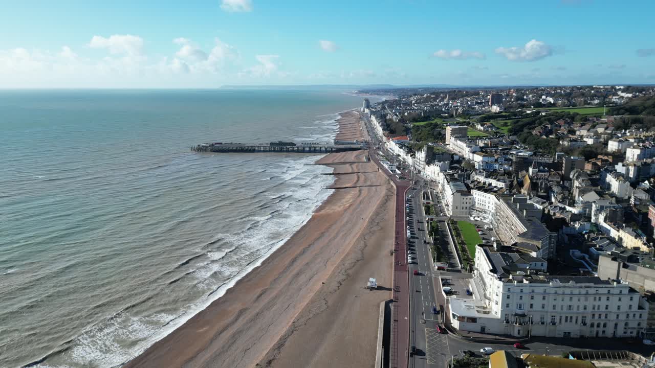 Aerial drone shot of Hastings UK, Wide Pull Away Tracking shot of Hastings Beach, Hastings Pier and coast line