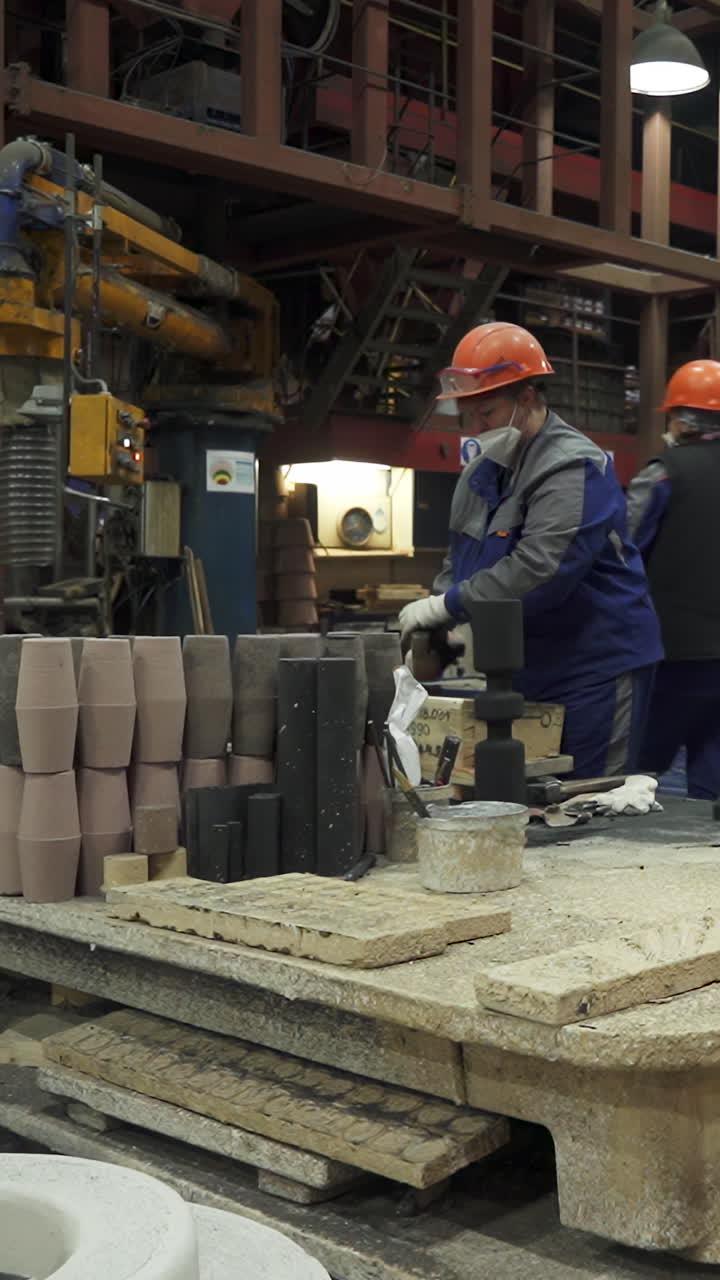 Factory Worker Assembling Materials