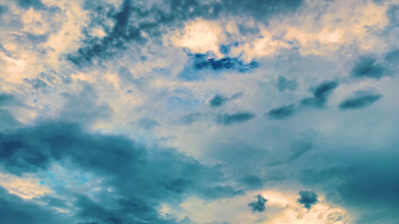Birds Flying at Dramatic vibrant abstract Sky with Heavy Cloud Formations at sunrise time