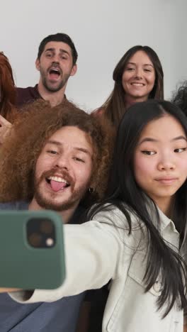 multiethnic friends taking selfie on smartphone