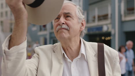 portrait of stylish elderly man smiling cheerful wearing white suit enjoying urban sightseeing travel