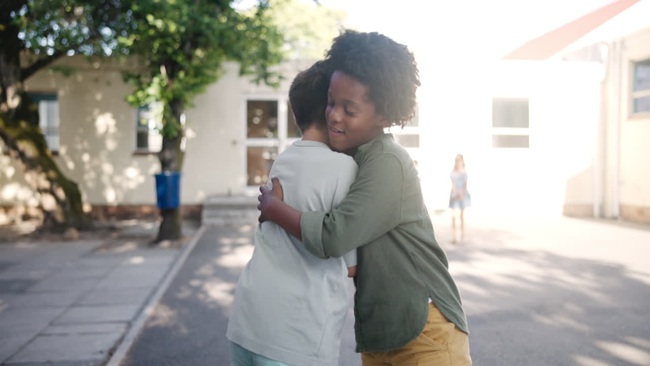 Two boys hugging in a schoolyard