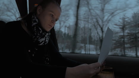 Business-woman-in-train-working-with-pad-and-papers