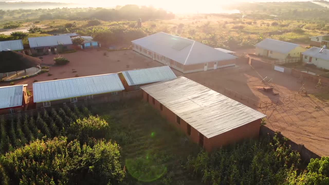 Buildings in Dzaleka Refugee Camp on Golden Hour, Malawi, Africa, Drone View