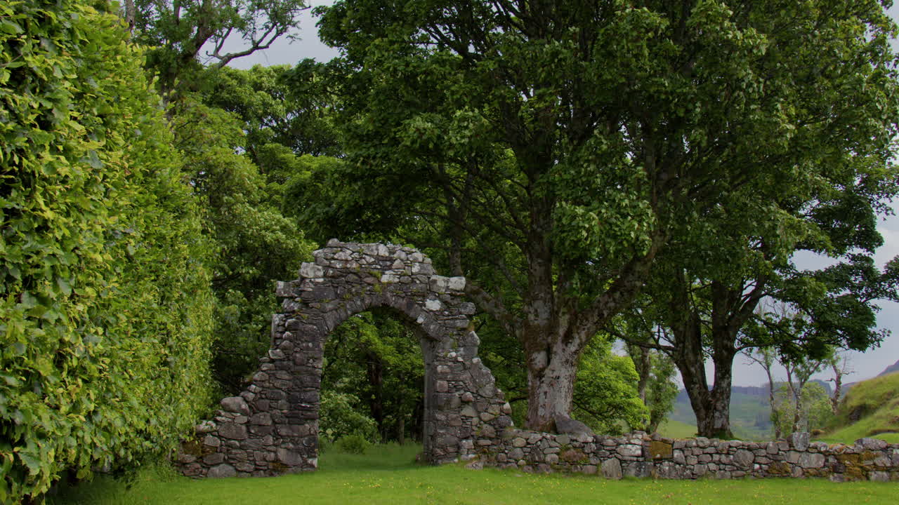 panning shot right to left looking across the grounds of Carnasserie Castle