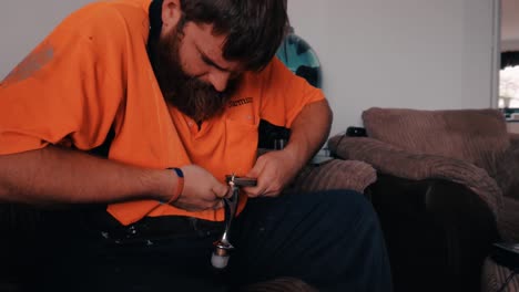 Bearded-Man-Works-On-Kitchen-Taps