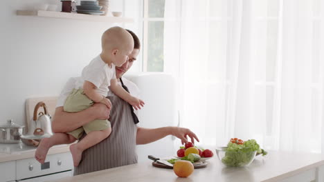 father and baby in the kitchen preparing food