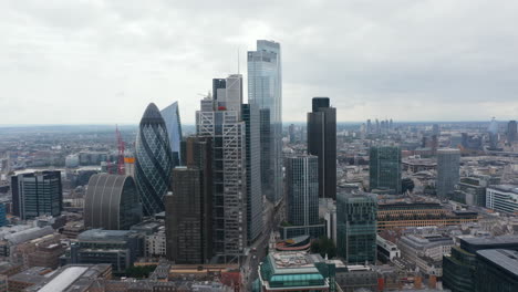 Backwards-reveal-of-buildings-around-financial-and-economic-hub-in-City-district.-Group-of-modern-skyscrapers.-London,-UK