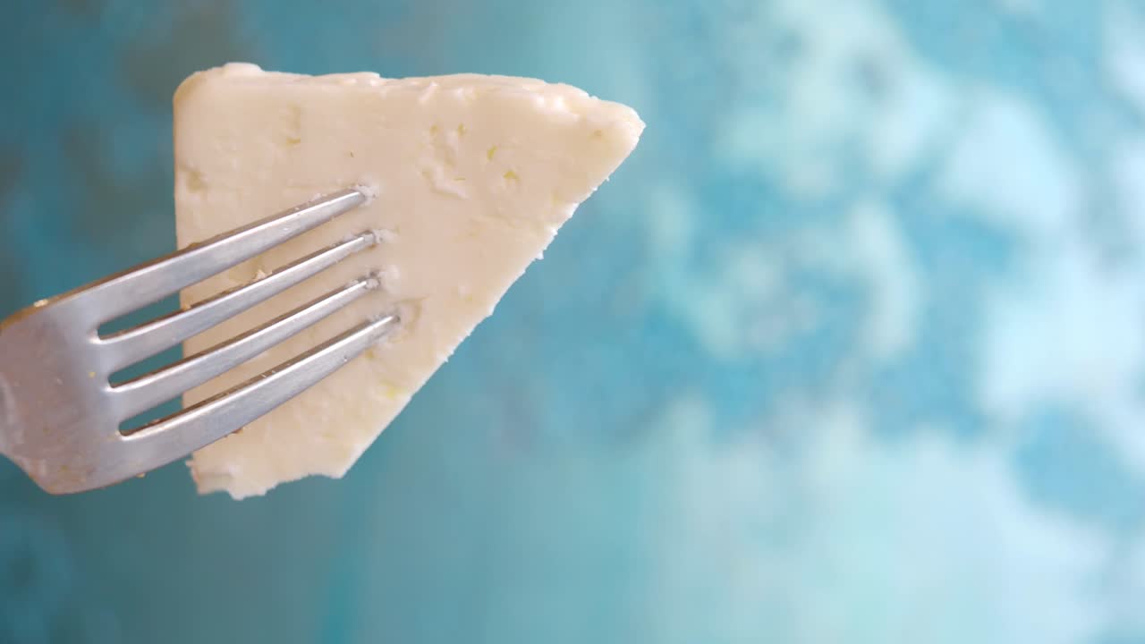 Piece of White Cheese on a Fork