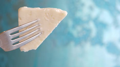 piece of white cheese on a fork