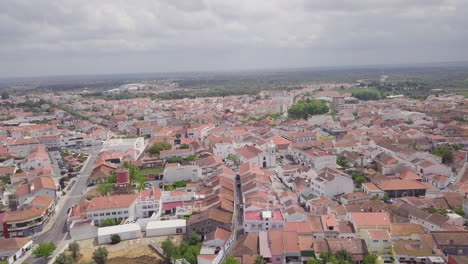 aerial drone shot flying over the terracotta roofs in grandola, a small town in portugal