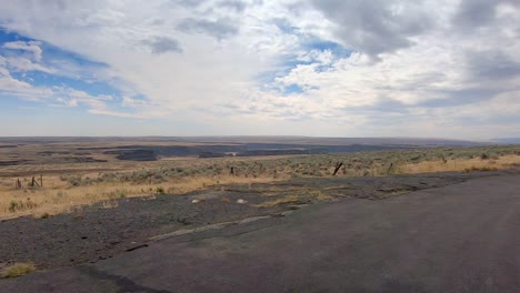 Pan-of-the-Okanogan-Highlands-of-north-central-Washington-State-with-an-off-road-vehicle-and-labradoodle-dog-in-the-foreground