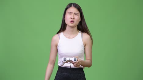 young beautiful asian businesswoman playing games