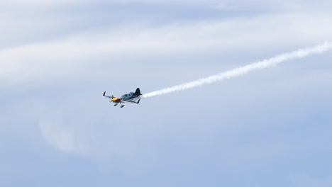 planes execute coordinated aerial maneuvers with smoke trails