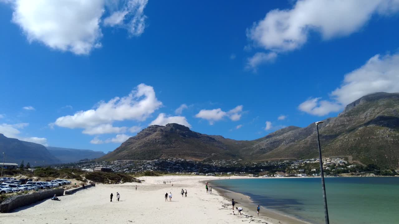 Time lapse of clouds moving over Hout Bay beach on a sunny day, South Africa.