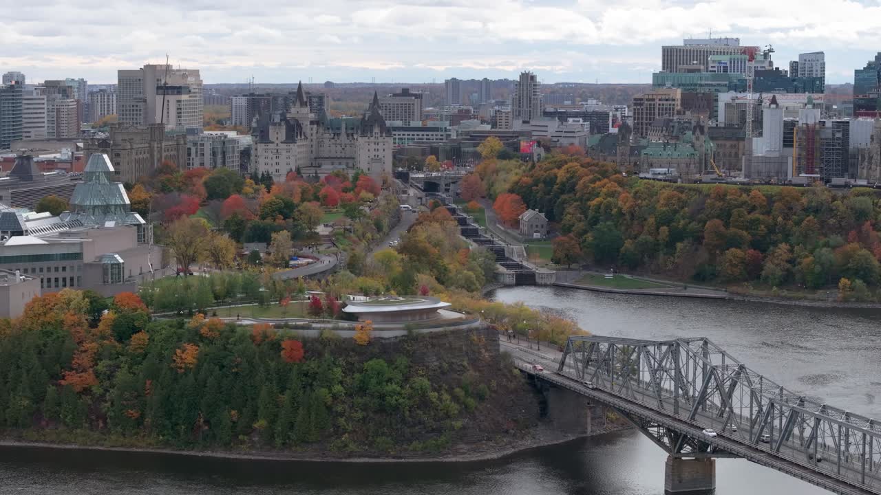 National Art Gallery and Alexandra Bridge over Ottawa River in foreground with Parliament Hill in background in Ottawa in fall