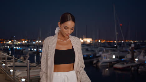 stylish woman at night marina