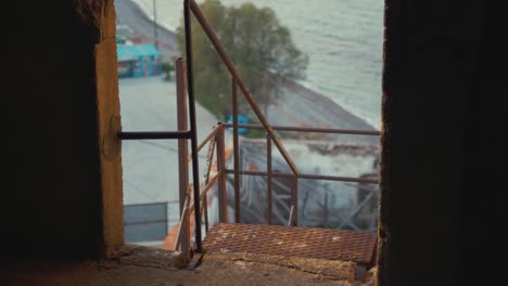 Old-rustic-stairs-of-abandoned-factory-sea-in-background