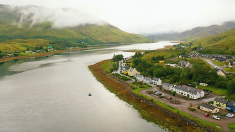 aerial reveal of small coastal village called dornie on sea loch in scottish highlands, west coast of scotland