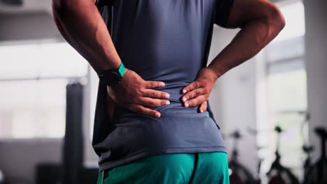 man with back pain in gym
