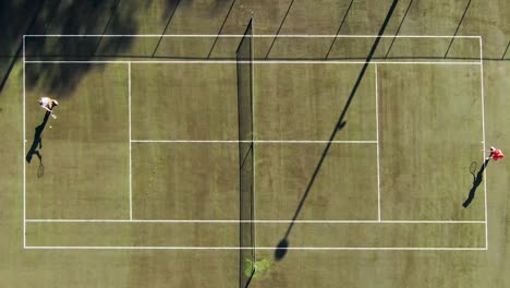 Top-down-aerial-shot-of-two-women-playing-tennis