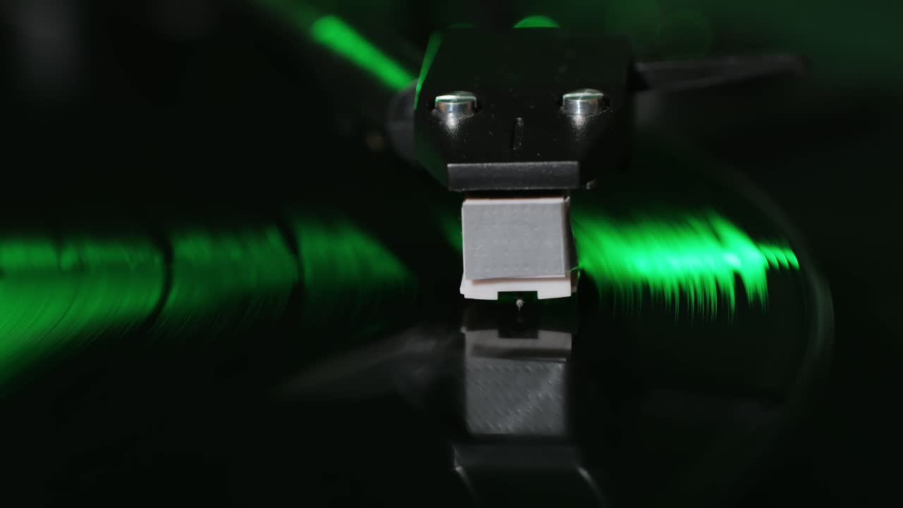 Retro Vinyl record player playing music, close-up macro shot of vintage LP disc old phonograph spinning. Retro music player.