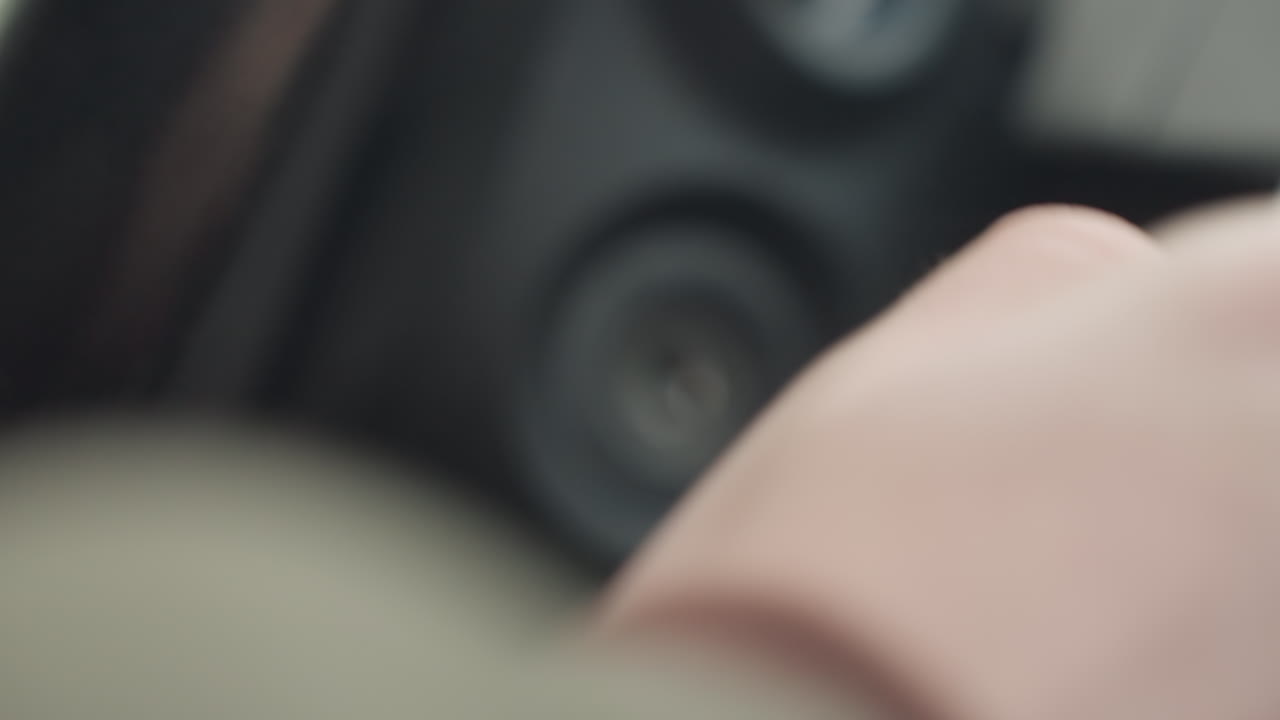 close up of ignition area showing fair skinned person removing car key from keyhole, focus on key position and dashboard texture, capturing subtle vehicle interaction in indoor winter light