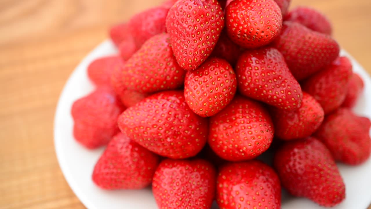 Strawberry on a wood background. Shooting in the movement